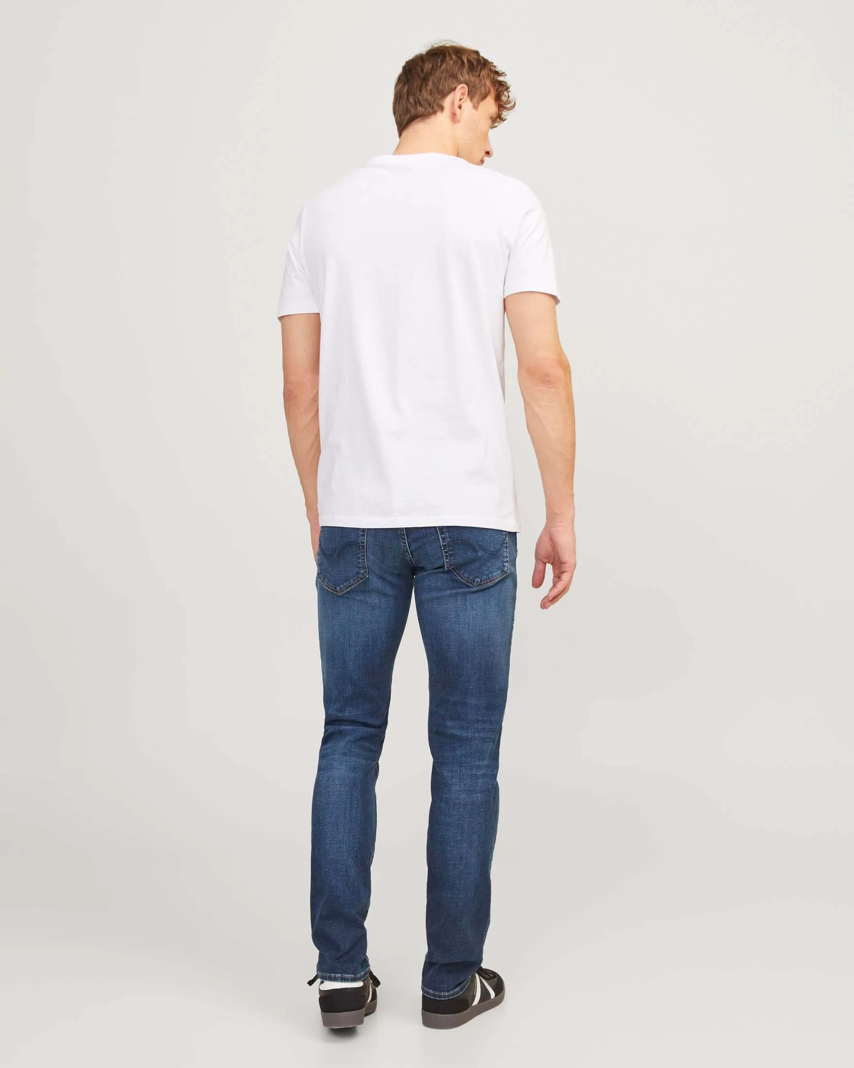 Jeans slim-fit a vita bassa in cotone stretch lavaggio medio stone washed con baffature e sabbiature